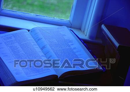Stock Image - Open Bible at window side. Fotosearch