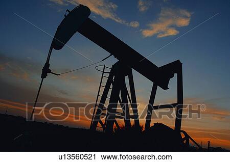 Silhouetted oil rig View Large Photo Image Stock Image - Silhouetted oil rig. Fotosearch