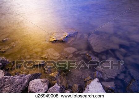 Sunset reflection in water View Large Photo Image Stock Photo - Sunset reflection in water. Fotosearch