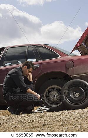 Tire frustrations at roadside View Large Photo Image Stock Photo - Tire frustrations at roadside. Fotosearch