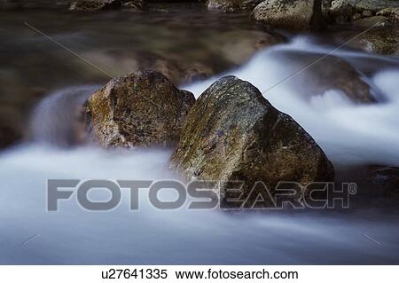 Water moving around large boulders View Large Photo Image Stock Photography - Water moving around large boulders. Fotosearch