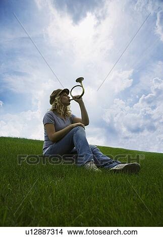 Woman playing horn View Large Photo Image Picture - Woman playing horn. Fotosearch