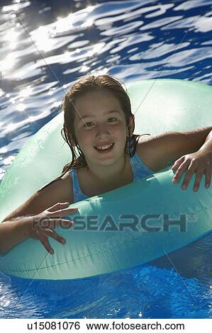 Young girl playing in water inside tube View Large Photo Image Stock Photograph - Young girl playing in water inside tube. Fotosearch