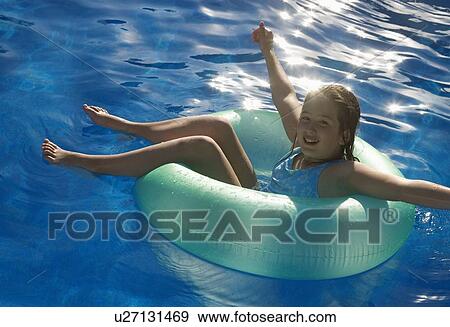 Young girl playing in water on tube View Large Photo Image Stock Photo - Young girl playing in water on tube. Fotosearch