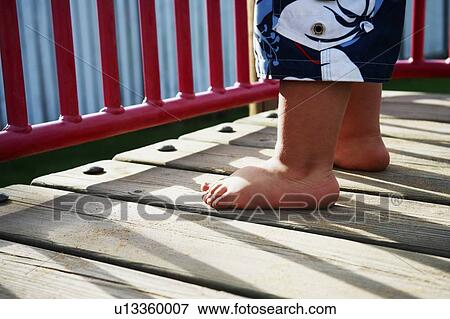 Childs feet in playground View Large Photo Image Stock Photo - Childs feet in playground. Fotosearch