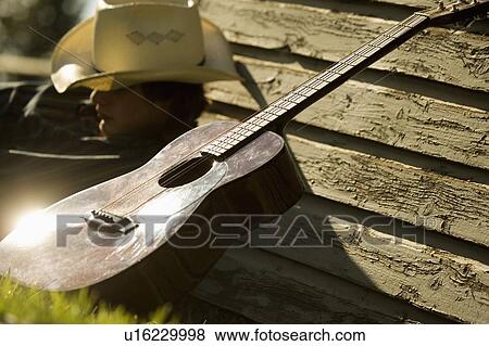 Cowboy and his guitar View Large Photo Image Stock Photo - Cowboy and his guitar. Fotosearch