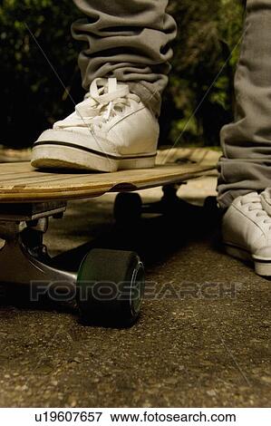 Stock Photo - Feet on skateboard. Fotosearch