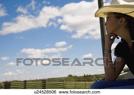 Girl on farm wearing cowboy hat View Large Photo Image Stock Photograph - Girl on farm wearing cowboy hat. Fotosearch