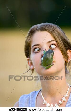 Girl with frog on her face View Large Photo Image Stock Photograph - Girl with frog on her face. Fotosearch