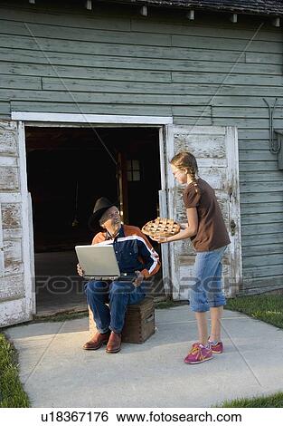 Granddaughter bringing pie to her grandfather View Large Photo Image Stock Photograph - Granddaughter bringing pie to her grandfather. Fotosearch