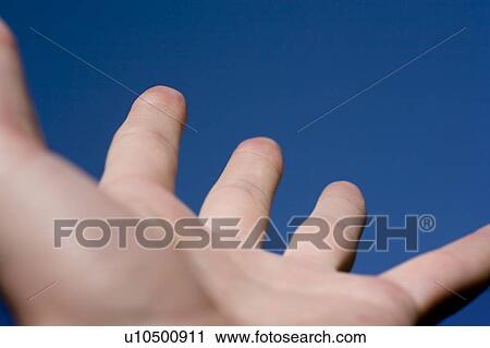 Stock Image - Hand reaching to the sky. Fotosearch