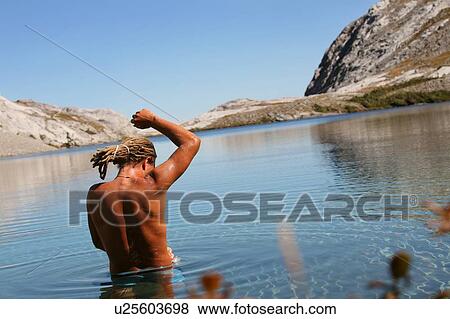 Man bathing in mountain lake View Large Photo Image Stock Photo - Man bathing in mountain lake. Fotosearch