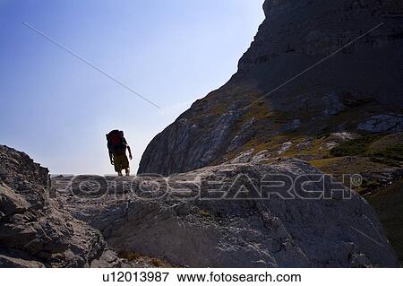 Stock Photo - Man hiking in mountains. Fotosearch