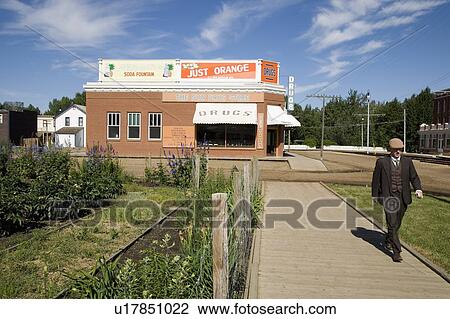 Stock Image - Man walking in historical town. Fotosearch