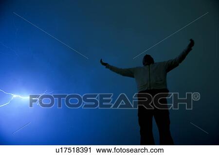 Man with outstretched arms in lightning storm View Large Photo Image Stock Image - Man with outstretched arms in lightning storm. Fotosearch