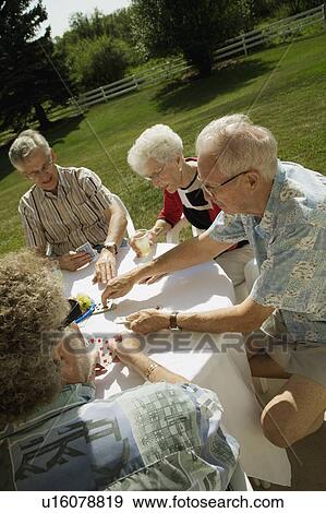 Stock Photo - People playing cards. Fotosearch