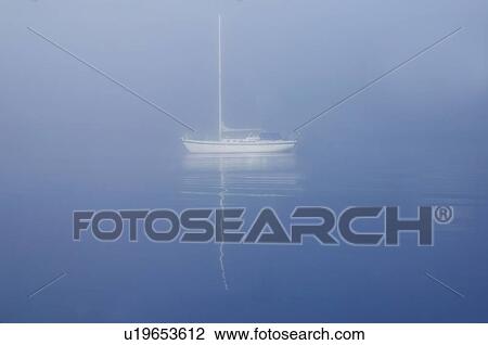 Sailboat drifting on water View Large Photo Image Stock Image - Sailboat drifting on water. Fotosearch
