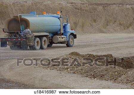 Water truck on dirt road View Large Photo Image Stock Photo - Water truck on dirt road. Fotosearch