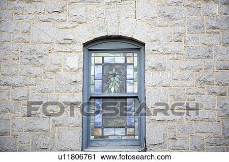 Stock Image - Window on exterior of stone wall. Fotosearch