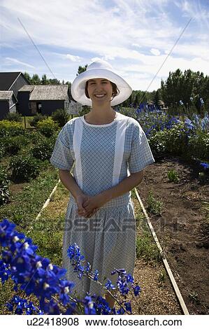Woman in flower garden View Large Photo Image Stock Photo - Woman in flower garden. Fotosearch