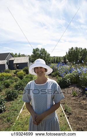 Woman in old-fashioned clothing standing in garden View Large Photo Image Stock Photo - Woman in old-fashioned clothing standing in garden. Fotosearch