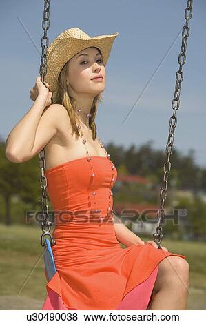 Stock Photo - Woman on a swing. Fotosearch