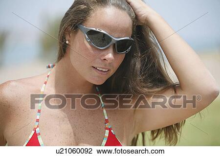 Woman wearing sunglasses and bikini View Large Photo Image Stock Image - Woman wearing sunglasses and bikini. Fotosearch