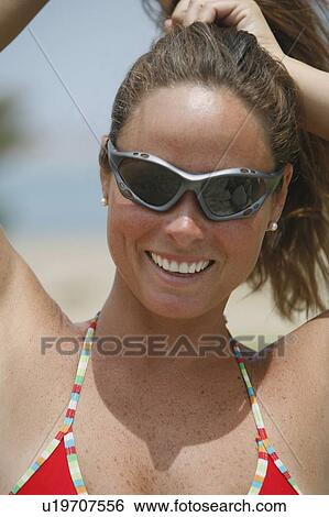 Woman wearing sunglasses and bikini View Large Photo Image Stock Photograph - Woman wearing sunglasses and bikini. Fotosearch