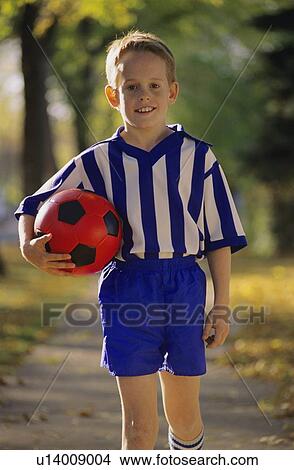 Picture - Young boy wearing soccer uniform. Fotosearch