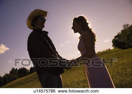 Stock Photograph - Young couple holding hands. Fotosearch
