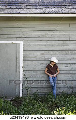 Young cowgirl on farm View Large Photo Image Stock Photograph - Young cowgirl on farm. Fotosearch