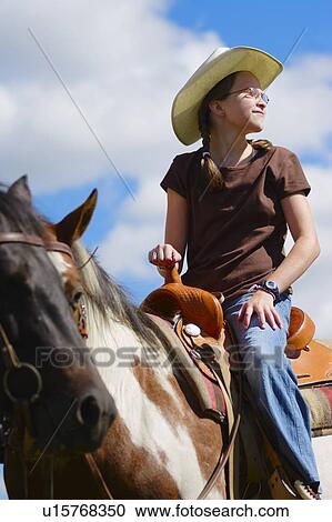 Young girl riding horse View Large Photo Image Stock Image - Young girl riding horse. Fotosearch