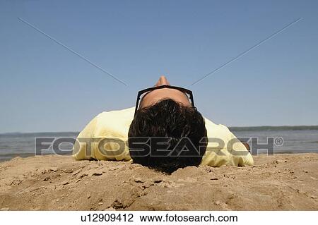 Young man on beach View Large Photo Image Stock Image - Young man on beach. Fotosearch