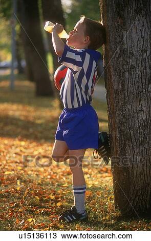 Young soccer player drinking juice View Large Photo Image Stock Image - Young soccer player drinking juice. Fotosearch