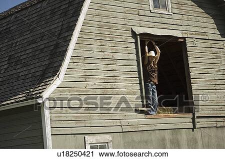 Young woman in barn loft View Large Photo Image Stock Image - Young woman in barn loft. Fotosearch