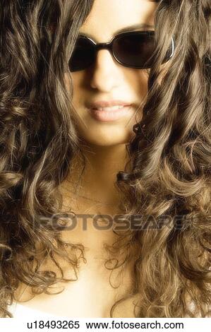 Young woman with curls and glasses View Large Photo Image Stock Photography - Young woman with curls and glasses. Fotosearch