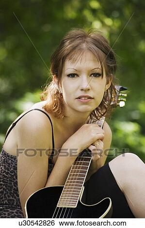 Young woman with guitar View Large Photo Image Stock Photograph - Young woman with guitar. Fotosearch