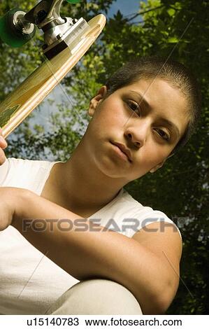 Young woman with skateboard View Large Photo Image Stock Image - Young woman with skateboard. Fotosearch