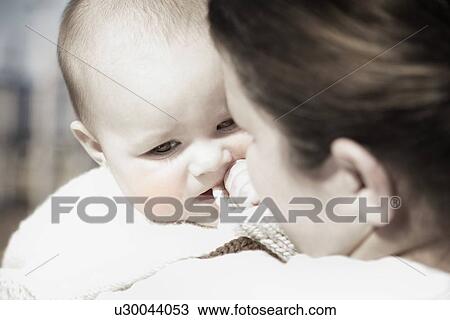 Baby on mother's shoulder View Large Photo Image Stock Image - Baby on mother's shoulder. Fotosearch