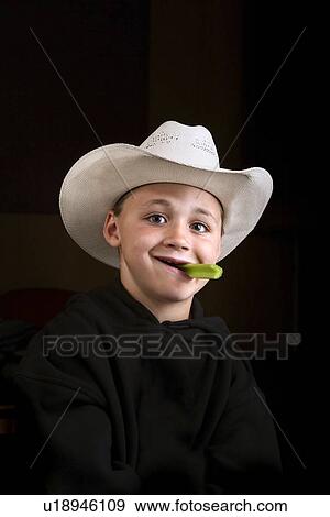 Boy eating a celery stick View Large Photo Image Stock Photo - Boy eating a celery stick. Fotosearch