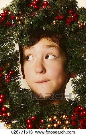 Boy in Christmas wreath View Large Photo Image Stock Image - Boy in Christmas wreath. Fotosearch