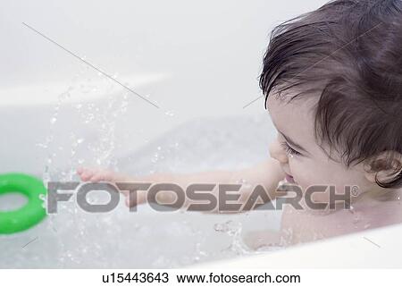 Stock Image - Boy taking a bath. Fotosearch