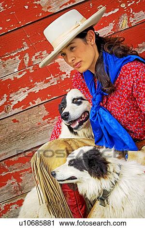 Cowgirl with two dogs View Large Photo Image Stock Image - Cowgirl with two dogs. Fotosearch