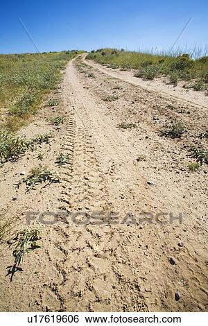 Stock Photograph - Dirt road with tire tracks. Fotosearch