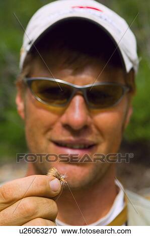 Stock Image - Fly fisherman with bait. Fotosearch