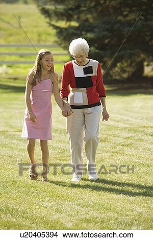 Picture - Grandmother and granddaughter holding hands. Fotosearch