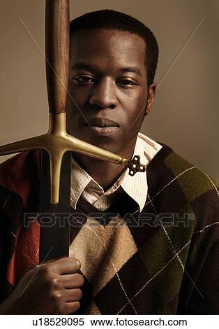Man holding a sword View Large Photo Image Stock Photography - Man holding a sword. Fotosearch