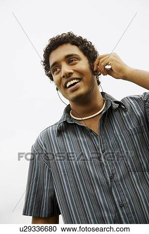 Stock Image - Man listening to music. Fotosearch