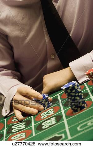Stock Photograph - Man playing roulette. Fotosearch