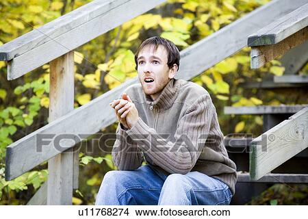 Man sitting on stairs View Large Photo Image Picture - Man sitting on stairs. Fotosearch